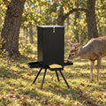 90 lb gravity deer feeder in the woods with a buck feeding